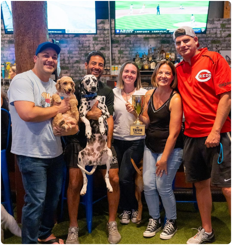 Dogs and owners enjoying at a sports bar