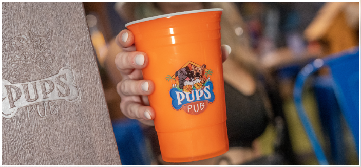 Glass of beer organge with logo pups pub