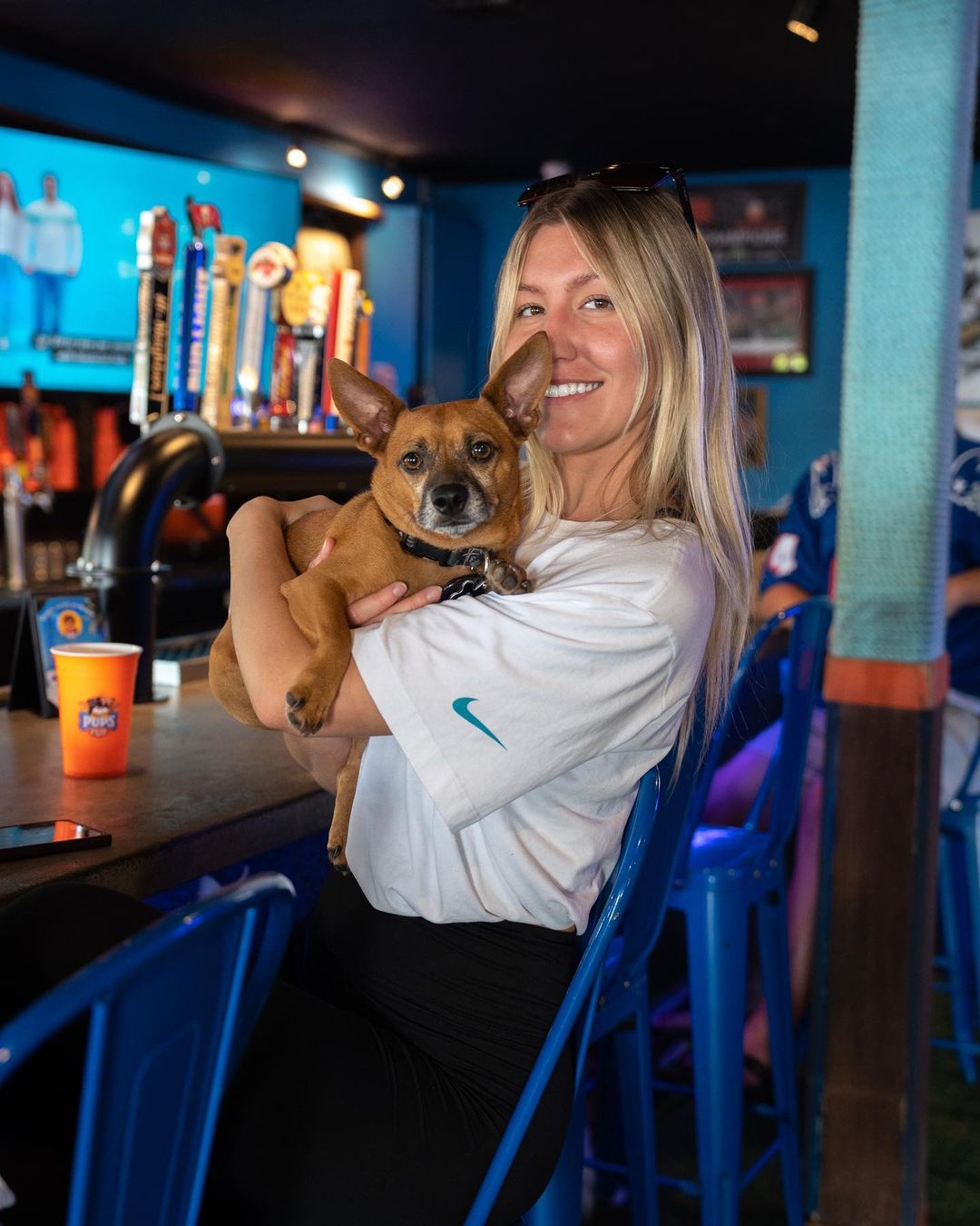 Dog and Woman standing at a bar